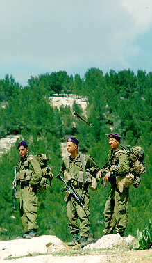 Photo: Three Israeli soldiers framed against the mountain