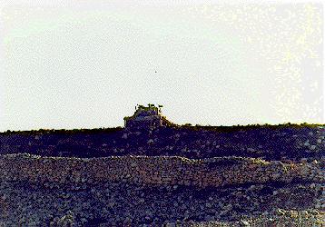 Photo: Tank on hill, above wall